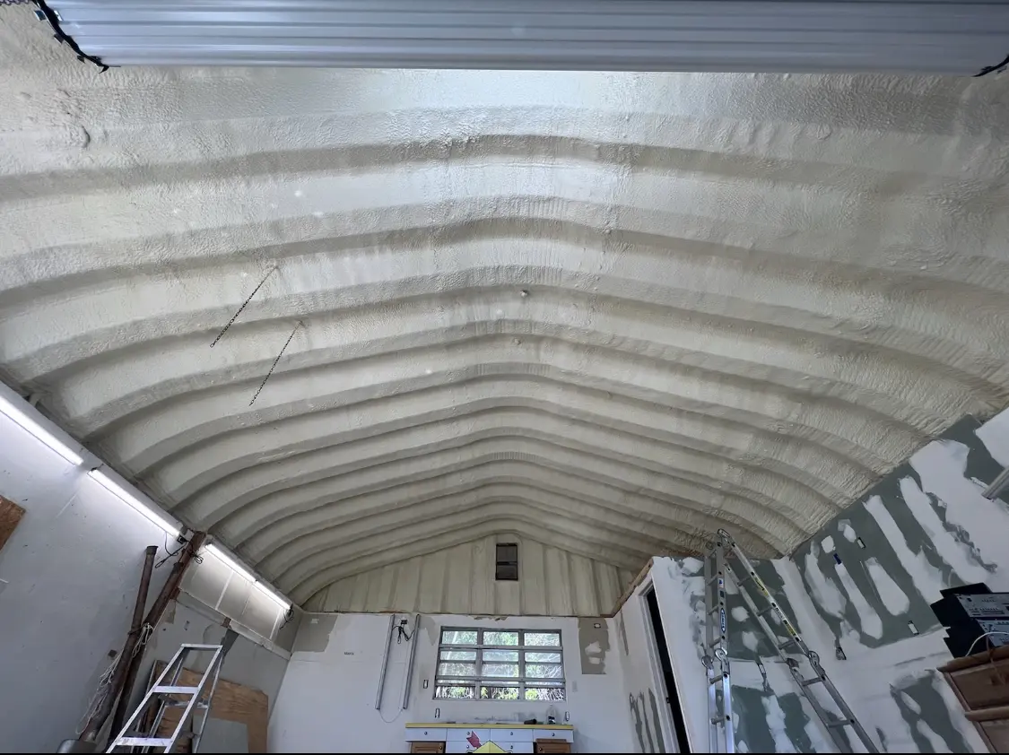 Spray polyurethane foam applied to the underside of a metal roof deck in Greensburg